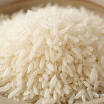 Рассыпчатый белый рис басмати в керамической пиале крупным планом.